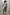 Thumbnail for Iconic Brown Leopard Jaspre Skirt in a satin wrap style, paired with a light blue shirt and colourful clutch.