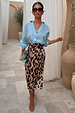 Iconic Brown Leopard Jaspre wrap skirt styled with a light blue button-down shirt and tan sandals.