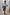Thumbnail for Satin Brown Leopard Jaspre wrap skirt paired with a light blue button-down shirt and sunglasses.
