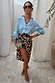 Satin Brown Leopard Jaspre wrap skirt paired with a light blue button-down shirt and sunglasses.