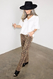 Wide-leg Leopard Lucia Scallop Detail Jeans styled with a white V-neck tee and black hat.