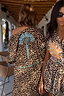 Iconic Leopard Kimono featuring a blue palm motif and contrast whipstitch, worn by a model in a vacation setting.