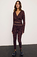 Dark Leopard Leggings with orange contrast detailing, styled with a matching wrap top in a supportive stretch fabric.