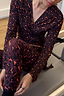 Dark Leopard Leggings and matching wrap top with contrast orange detailing, shown in a gym setting.