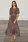 Leopard Lucia Dress featuring a sheer leopard print, voluminous puff sleeves and a tiered drop waist.