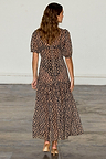 Leopard Lucia Dress in sheer animal print with puff sleeves and a tiered skirt, shown from the back.
