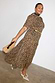 Leopard Lucia Sheer Midaxi Dress with puff sleeves and a tiered skirt, styled with a gold belt and neck scarf.