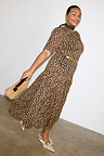Leopard Lucia Sheer Midaxi Dress with puff sleeves and a tiered skirt, styled with a gold belt and neck scarf.