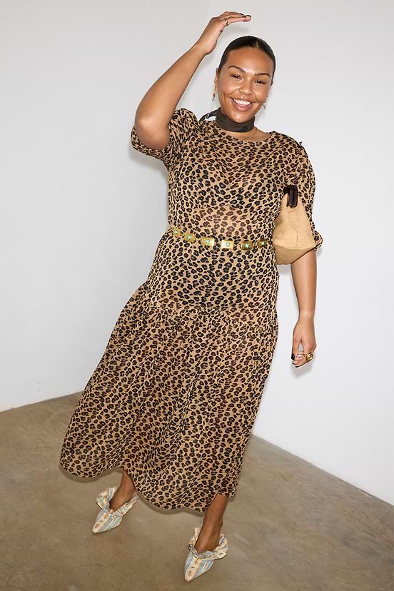 Sheer Leopard Lucia Dress featuring puff sleeves and a tiered drop-waist skirt on a smiling model.