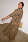 Leopard Lucia Dress with a sheer leopard print, puff sleeves and a tiered drop waist, worn by a size 14 model.