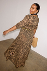 Leopard Lucia Dress with a sheer leopard print, puff sleeves and a tiered drop waist, worn by a size 14 model.