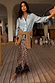 Thumbnail for Iconic Leopard Lace Midi Maeva Skirt with a black lace hem, styled with a blue shirt and tied tan jumper.
