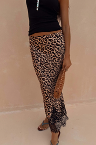 Leopard print Midi Maeva Skirt with a black lace border, styled with a black top and matching patterned clutch.