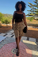 Leopard Lucia Scallop Pocket Long Shorts in brown denim, worn by a model for inclusive sizing in a vacation setting.