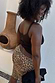 Leopard Lucia Scallop Pocket Long Shorts in brown animal print denim, styled with a brown vest and black clutch.