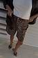 Thumbnail for Leopard Lucia Scallop Pocket Long Shorts in leopard print denim, styled with a white top and black blazer.