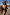 Thumbnail for Leopard print bandeau swimsuit with blue whipstitch trim and side-tie details, worn by a model on vacation.