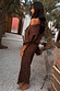 Petite Lucia Leopard Tilly Dress in iconic leopard print plissé with a multi-wear neckline in an outdoor courtyard.
