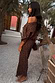 Thumbnail for Lucia Leopard Tilly Dress in plisse with an off-the-shoulder neckline, styled in an outdoor garden setting.