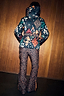 Leopard Ski Trousers with high waist and orange side zips, worn with a graphic patterned hooded ski jacket.