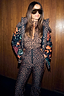 Iconic Leopard Ski Trousers with a high-waisted fit, styled with a matching leopard top and patterned ski jacket.