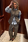 Iconic Leopard Waistcoat with engraved metal buttons, layered over a grey jumper and leopard barrel leg jeans.