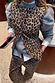 Iconic cotton Leopard Waistcoat with metal buttons, layered over a grey knit and matching leopard barrel jeans.
