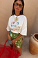 White Life Is Tough Embroidered T-Shirt with a colourful slogan, paired with a green printed mini skirt.