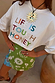 White Life Is Tough Embroidered T-Shirt featuring a colourful slogan and a relaxed, dropped shoulder fit.