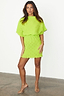 Lime Plisse Mini Tilly Dress featuring gold foil dots and wide sleeves, styled with gold heels.