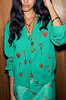 Turquoise Key Cardigan in a soft touch knit with a hand-painted lock and key print, worn with a matching skirt.