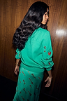 Turquoise Key Cardigan with embroidered lock and key motifs on the sleeve, styled with a matching print skirt.