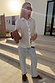 Sheer White Love Miley Shirt with heart motifs and blouson sleeves, styled with light jeans and a leopard print clutch.