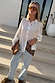 White Love Miley Shirt with tortoise buttons and red LOVE embroidery, styled with light wash denim jeans.