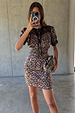 Cherry Leopard Mini Lyla Dress featuring black lace trim, tie neck and cherry print, shown in a mirror selfie.