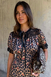 Cherry Leopard Mini Lyla Dress with black lace trims, ribbon tie neck, and a leopard print featuring tiny red cherries.