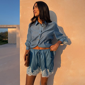 Blue Lace Maeva Shorts in washed blue satin with white lace trim and drawstring waist, styled with a matching shirt.