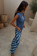 Blue Marina asymmetric top with gathered waist detailing and fish motifs, shown on a 5ft4 model wearing size S.