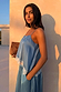 Blue Lace Swing Cami in a satin finish with a white lace-trimmed hem, worn by a model in warm evening sunlight.