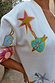 Dreamer Martha Cardigan in cream soft-touch knit featuring embroidered heart, star and sun motifs.