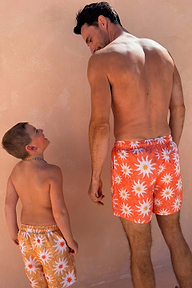 Men's Orange Sun Swim Shorts in a Soleil print, shown with matching kids shorts for family energy.