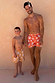 Men's Orange Sun Swim Shorts in the signature Soleil print, shown on a man and child for family vacation matching.