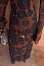 Tan Jaden Floral Mesh Dress featuring a gold sun and eye charm chain belt for a vacation look.