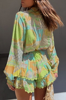 Isla Ruffle Shorts featuring a green hand-painted print, tiered ruffles and lace trim, styled as a co-ord set.