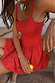 Thumbnail for Red Broderie Mini Lola Dress with a cotton palm broderie skirt, worn by a model on stone steps.