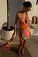 Green Abstract Leila Mini Dress featuring a deep cowl neck and multi-wear tie straps in a vibrant summer print.
