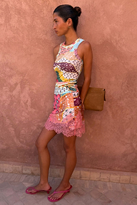 Pastel Morocco Mini Maeva Skirt featuring abstract palm and eye motifs and a pink lace border, styled with a matching top.