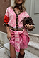 Pink Bandana Mini Dorris Skirt in a paisley print, styled with a leopard-trim cardigan for a transeasonal look.