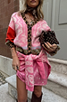 Pink Bandana Mini Dorris Skirt in a paisley print, styled with a leopard-trim cardigan for a transeasonal look.