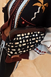 Black Beaded Mirror Bag with silver glass shapes and a wooden handle, held against a patterned cardigan.